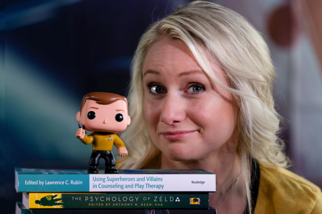 Justine poses next to a figurine of Captain Kirk.