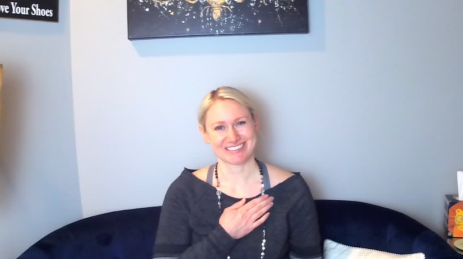 Justine smiles at the camera after completing a guided meditation.